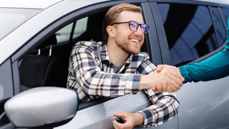 Shaking hand with new car buyer
