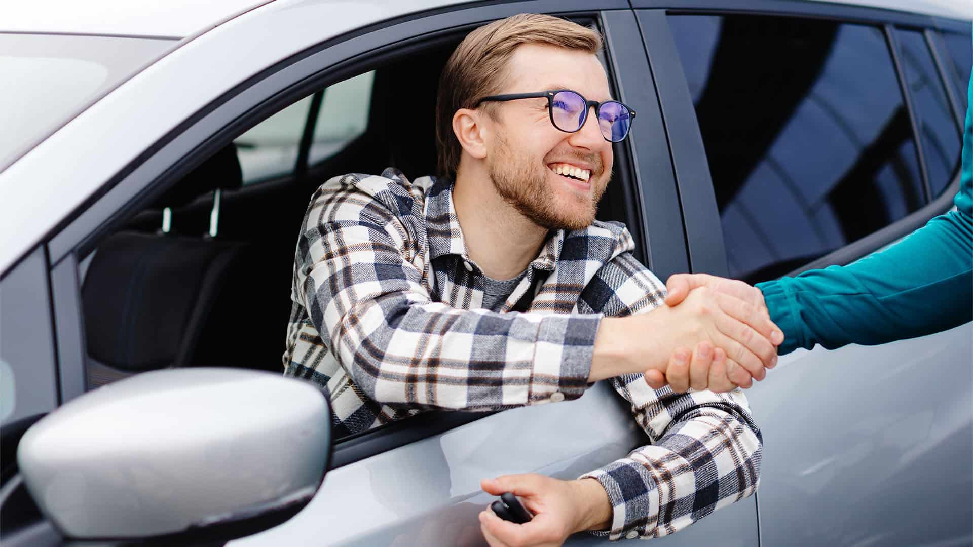 Shaking hand with new car buyer