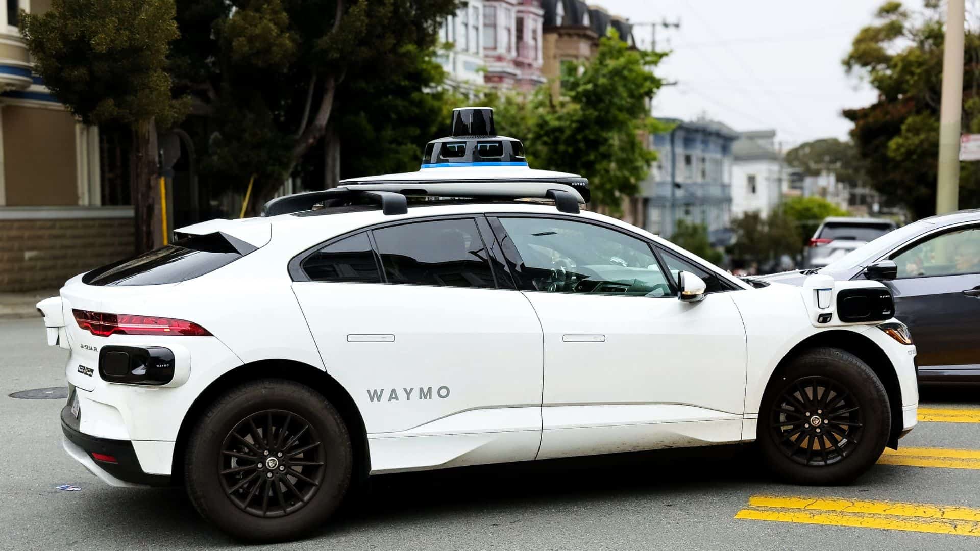 Waymo driverless electric vehicle navigating intersection