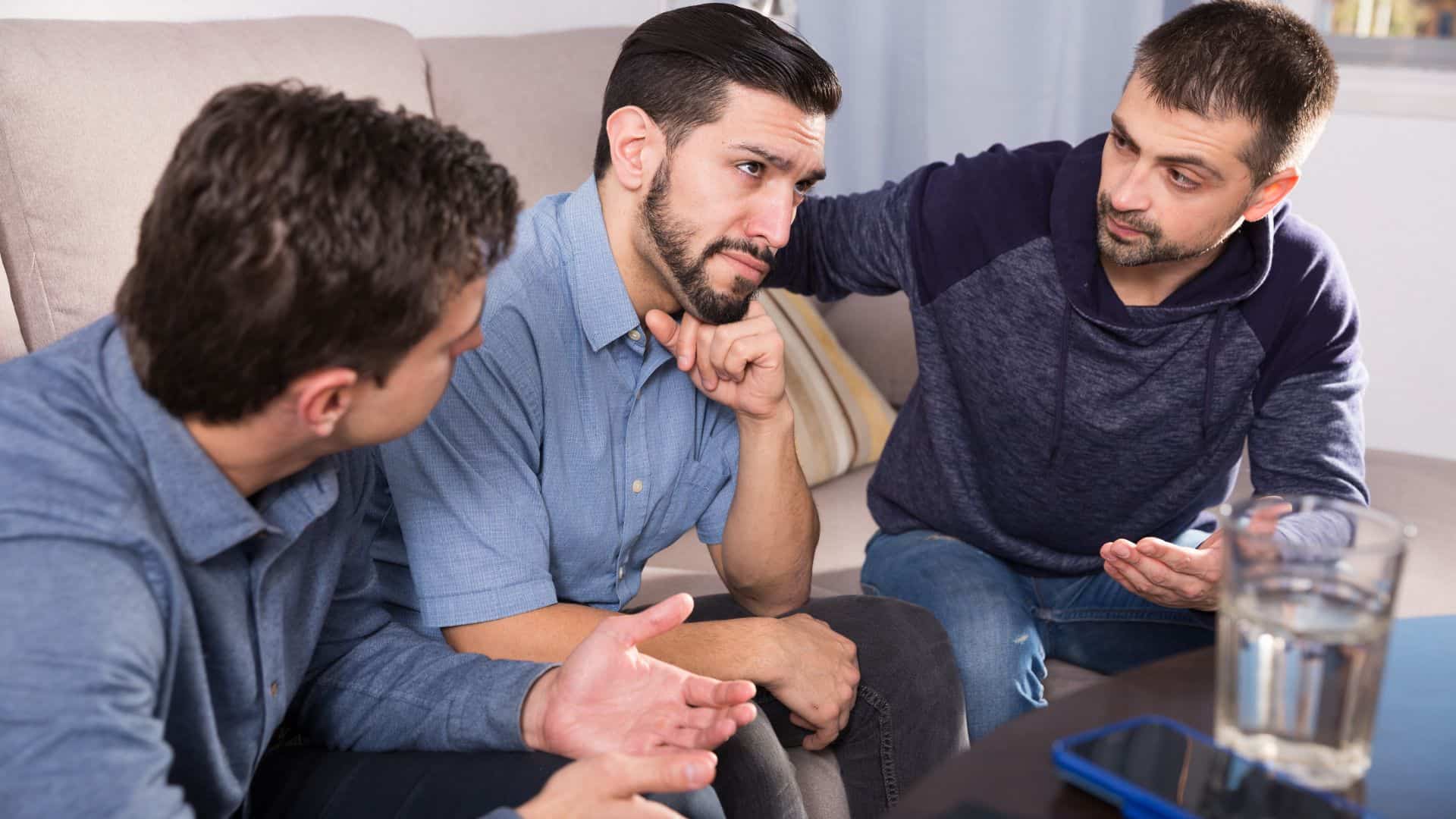 Three men sitting down having a conversation