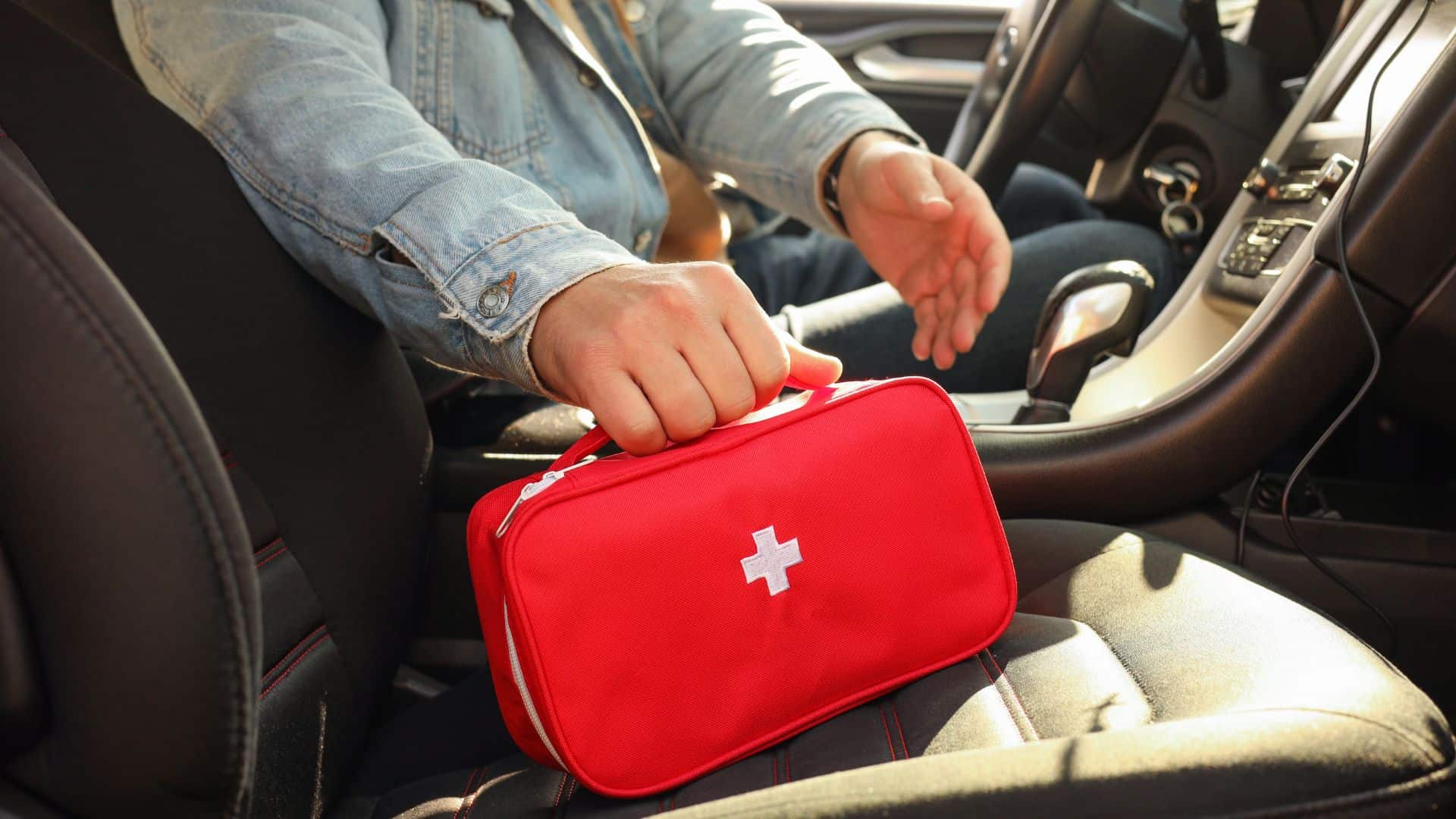Man holding car first aid kit
