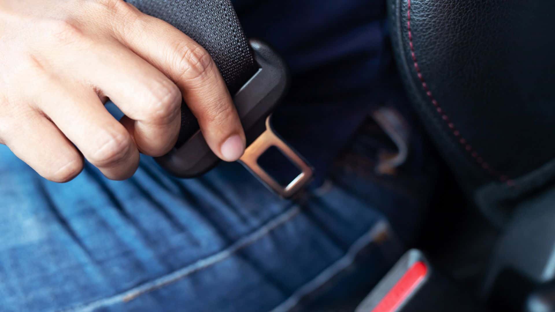 Man putting on a seatbelt