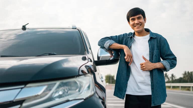 happy young man with a new car