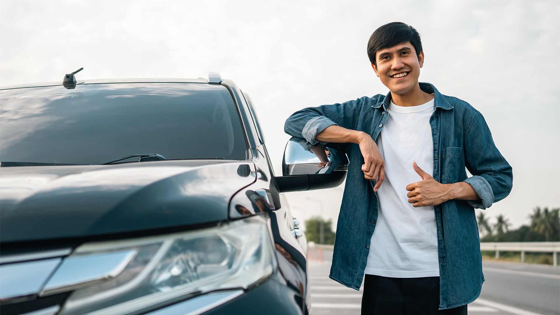 happy young man with a new car