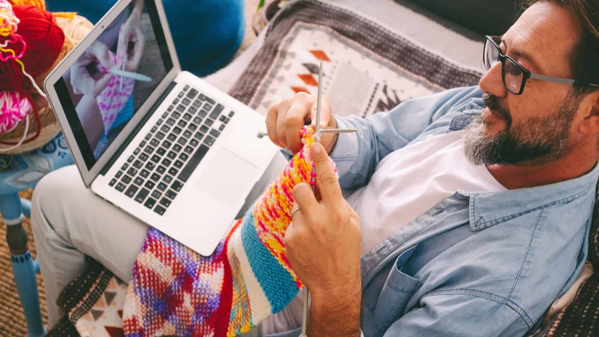 man crochetting