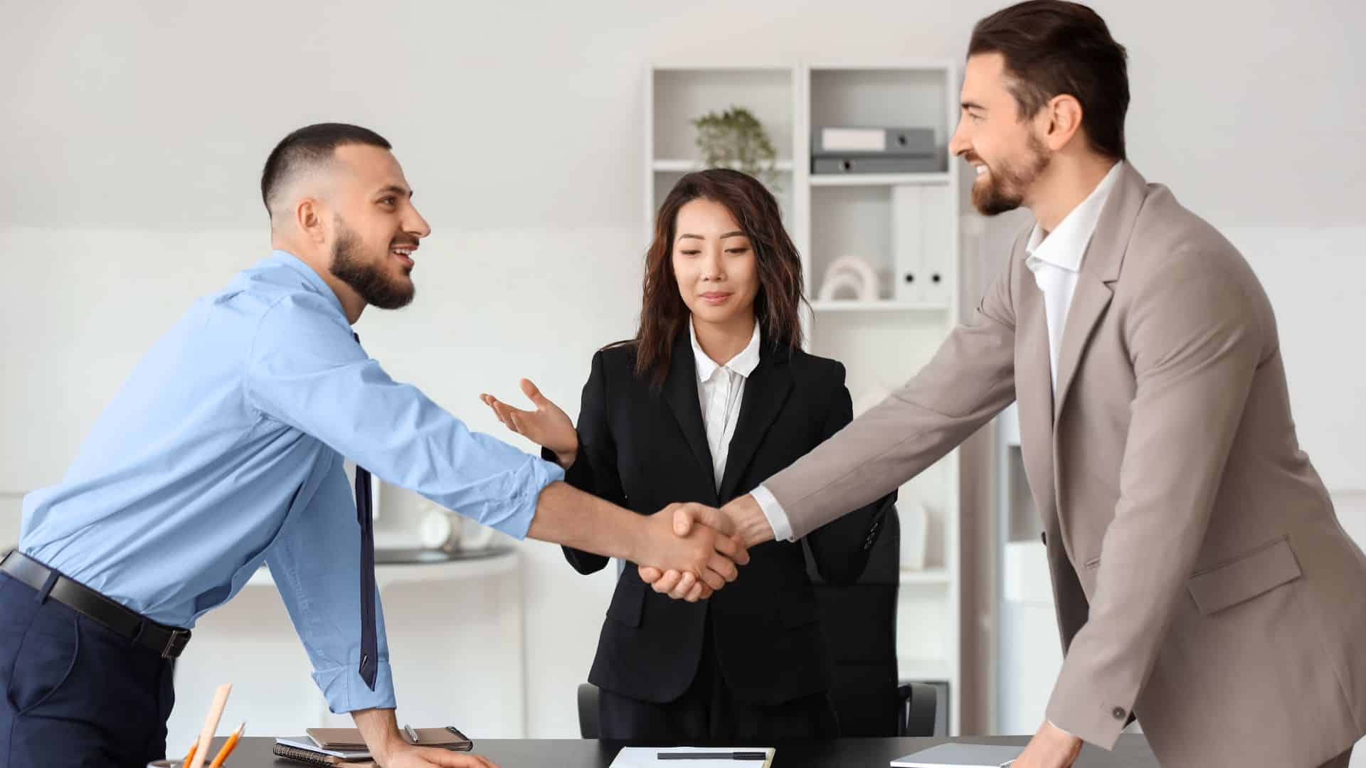 Two men in an office making a deal and shaking hands