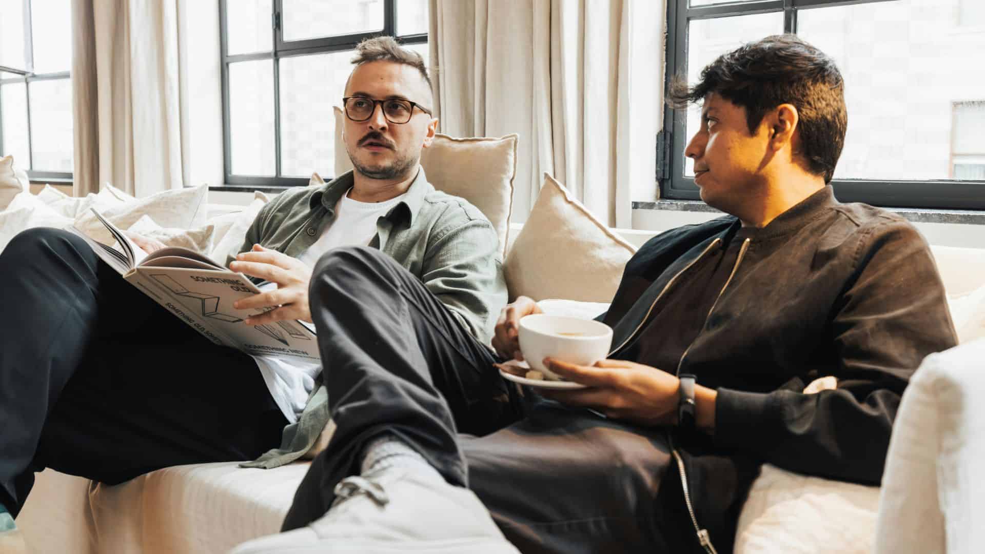 Two men hanging out, reading and having coffee