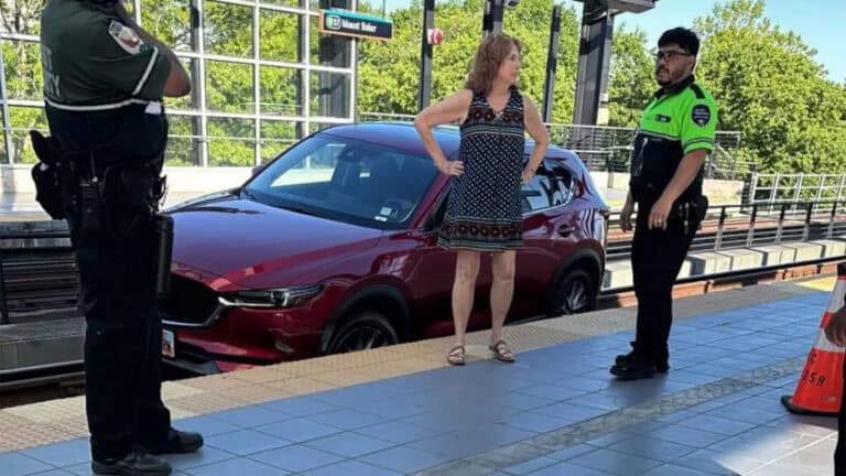 Woman droves car on a railway tracks