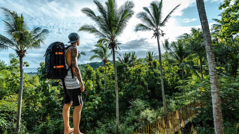 Man with a backpack in the jungle.
