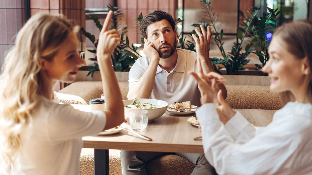Women argue, and a man is watching.