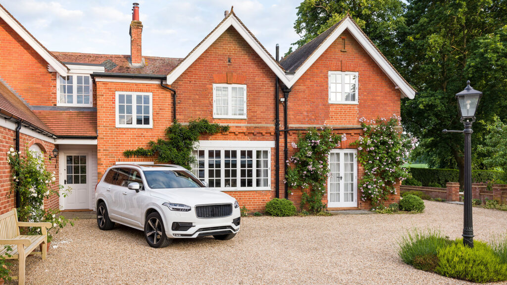 volvo parking in front of a house.
